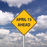 Caution road side that reads "April 15 Ahead"