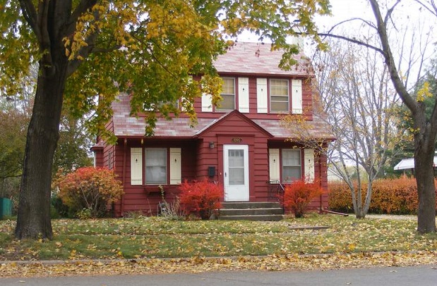 Exterior of house with fall colors on the trees and bushes.