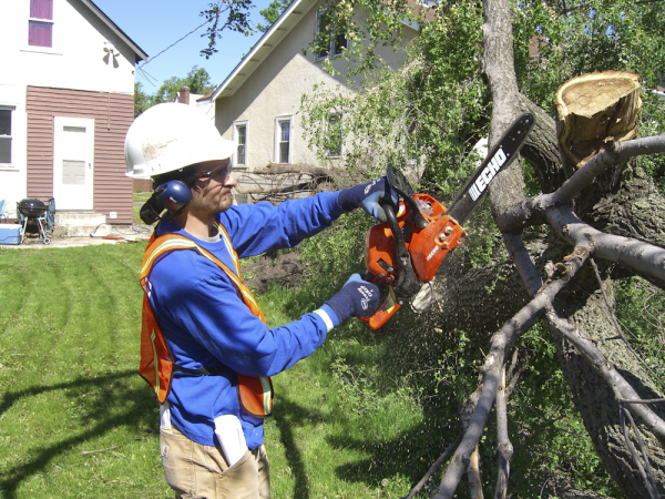 Habitat volunteer getting tornado-damaged homes ready for winter