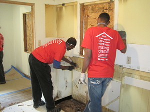 volunteers performing demolition for the home rehab project