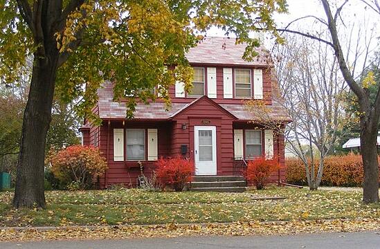 A picture of a colorful fall yard and house