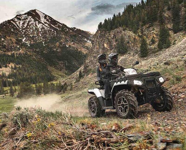 The Sportsman XP1000 ATV driving through the mountains.