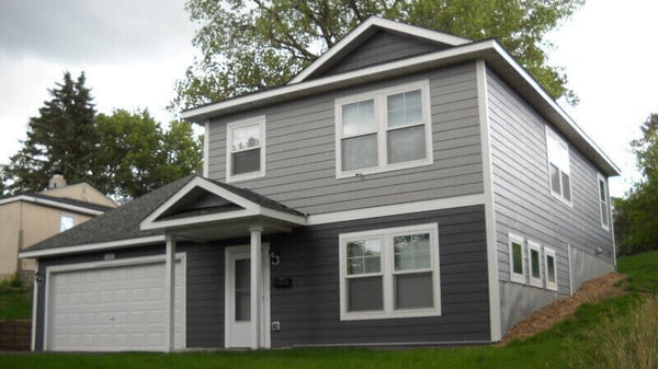 A two-story gray Habitat home.