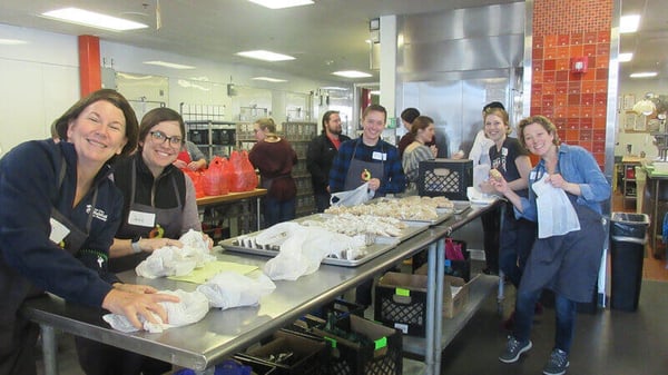 Volunteers preparing food in a kitchen.