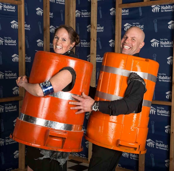 Ashley Rose and her husband at the Hard Hat & Black Tie Gala in 2018, wearing upside-down bins with reflective tape.