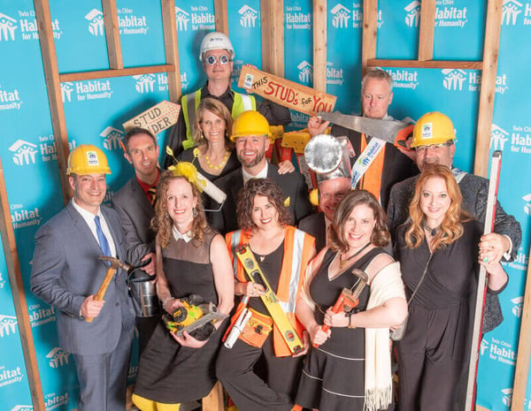 A group from the 2019 Hard Hat & Black Tie Gala, wearing various construction-related outfits.