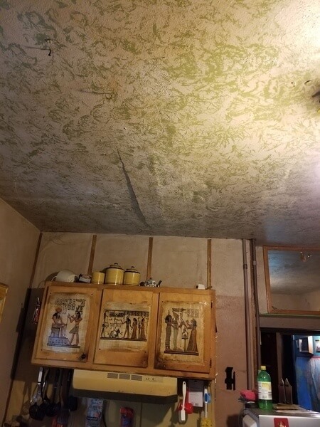 Water damage on the ceiling of the kitchen; the ceiling is slightly convex.