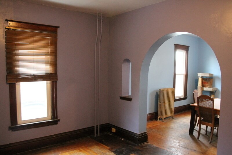 The new repaired and painted walls in the living room (painted lavender) and the dining room (painted blue). The floor and trim are hardwood.