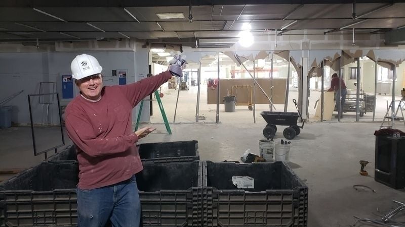 Pete O'Keefe showing off the demolition of one of the walls in the New Brighton ReStore during the remodel.