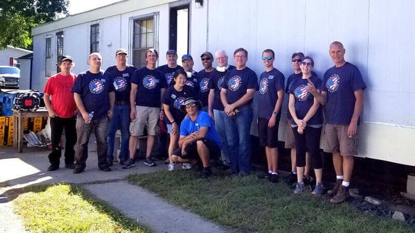 A group of volunteers outside Mark's home.