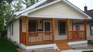 A Habitat home with a wooden front porch.