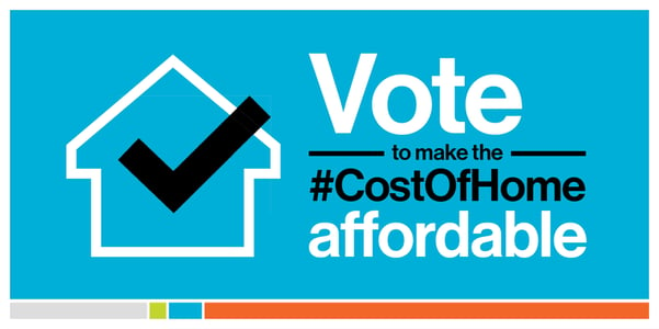 A bright blue background with a white outline of a house and a black checkmark inside on the left, on the right, white and black text saying "Vote to make the #CostOfHome affordable". At the bottom is a thin multi-colored line with gray, green, blue, and orange sections.