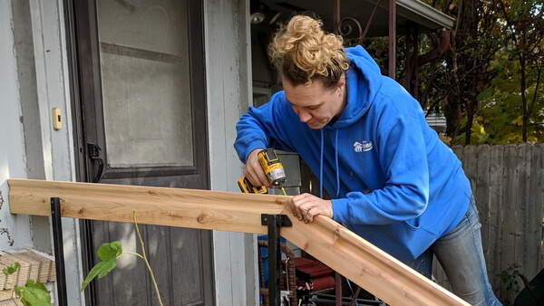 Ashley Realbanas installing a railing at a home.