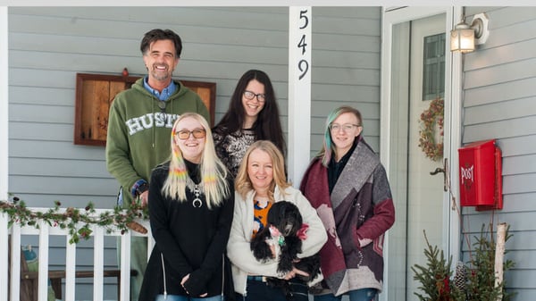 Jill and her family in front of their Habitat home.