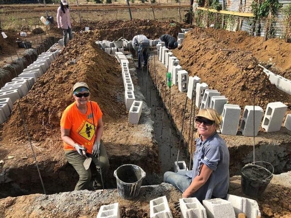 Volunteers working on the foundation of a home.