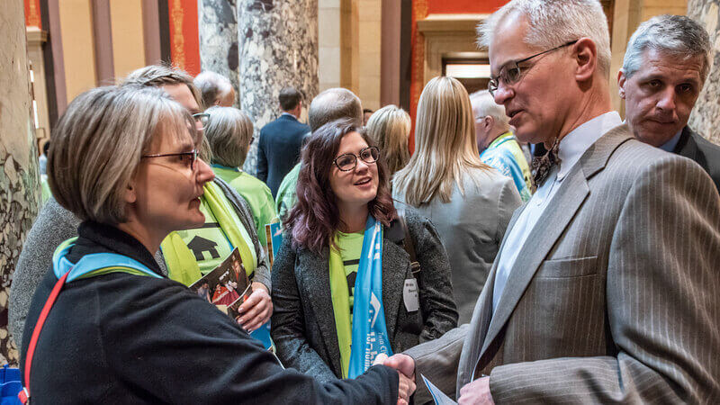 Habitat supporter talks with a legislator at the state capitol.