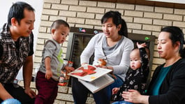 A family inside of their Habitat home living room.