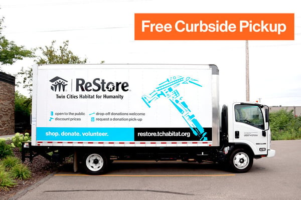 Outside on a parking lot sits a white truck that has the ReStore logo, a large light blue hammer made up of many tools, a blue bar at the bottom that says "shop. donate. volunteer.", a black bar to the right of it that says "restore.tchabitat.org". Above the bar on the truck is a series of short phrases next to light blue icons, saying "open to the public", "discount prices", "drop-off donations welcome", and "request a donation pick-up". Overlaying the image is an orange box saying "Free Curbside Pickup"