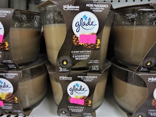 Scented Glade candles on a shelf.