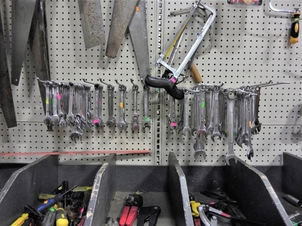 Display of hand tools, including wrenches and saws.