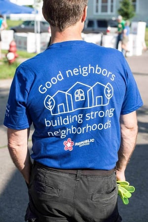 A man wearing a blue t-shirt saying "Good neighbors building strong neighborhoods, Republic Services"