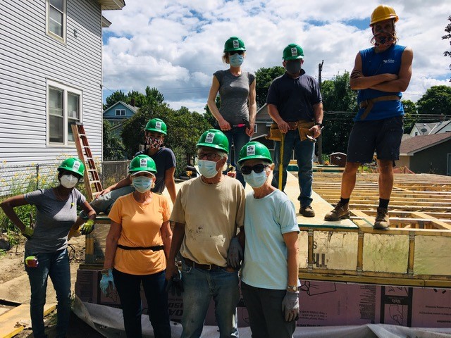 The Olsons with a group of volunteers on a build site.