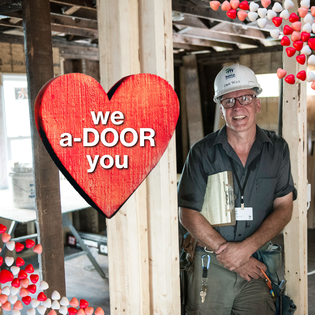 Site Supersvisor Jimi stands in a doorway and a valentine heart with "We a-DOOR you" is prominently displayed.