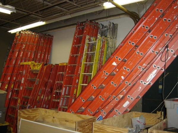 Multiple ladders in the warehouse.