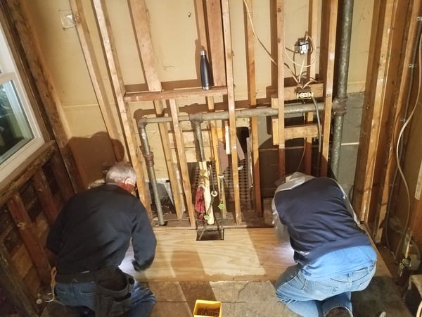 Staff working on plumbing in Karin's house.