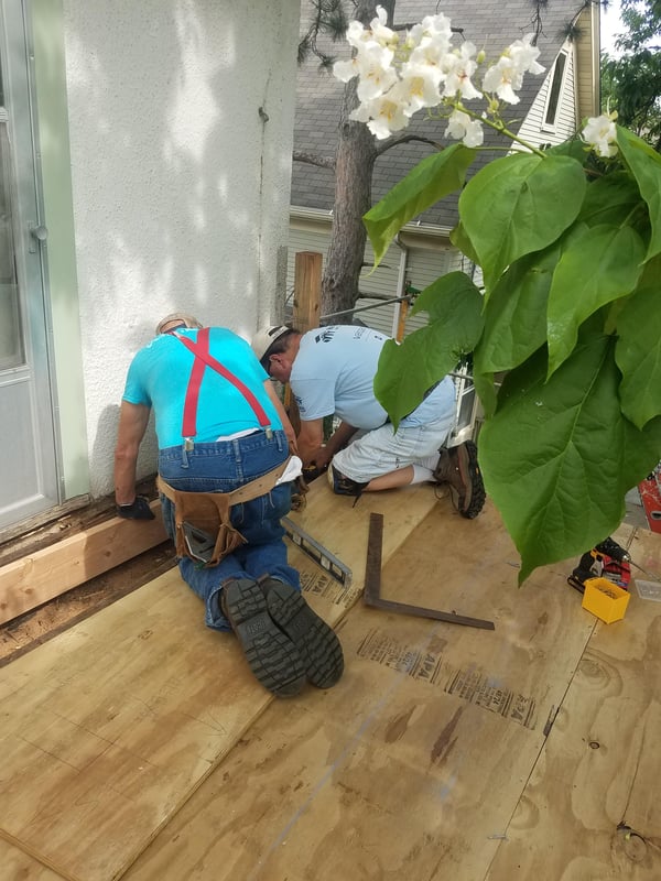 Volunteers working on Karin's back porch.