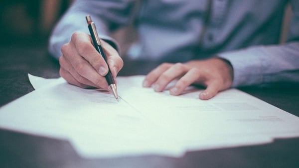 A man writing letters.