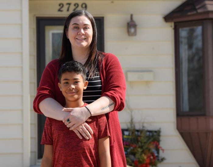 Brittany and son in front of their home - blog image