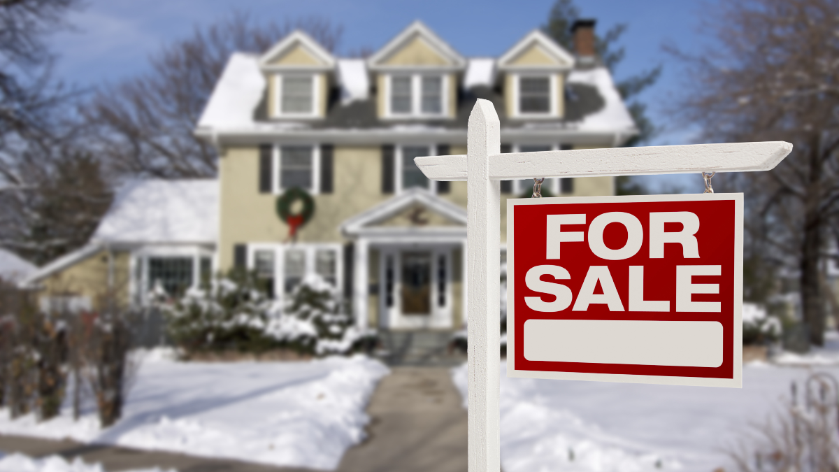 A for-sale sign in front of a home.