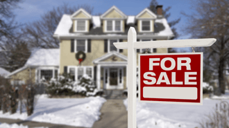 A home with a for sale sign.