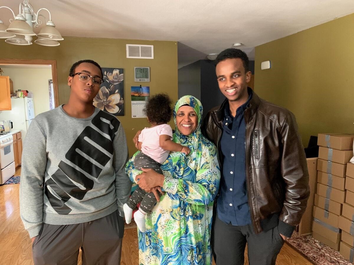 Hamida and her family in her home