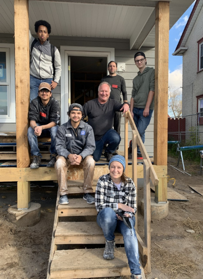 volunteers on front step of home