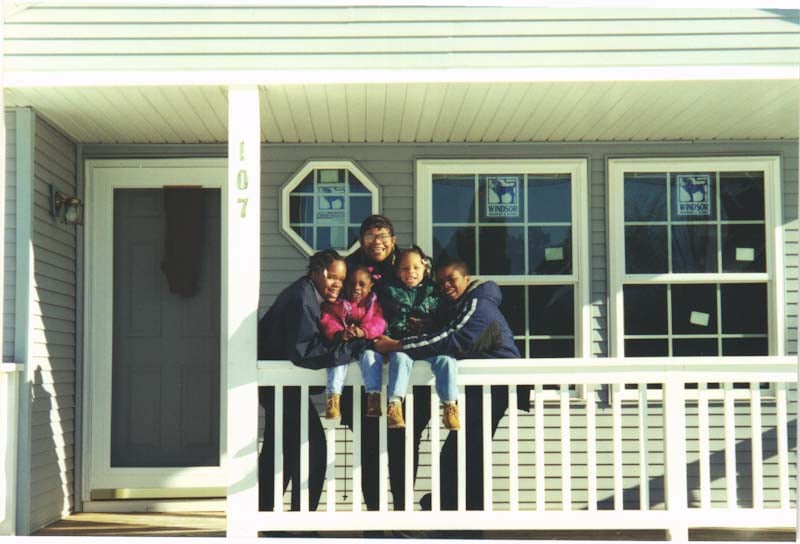 Carla and her family on the porch.