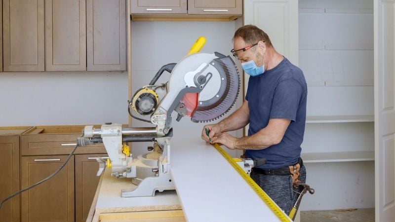 Measuring and sawing lumber.