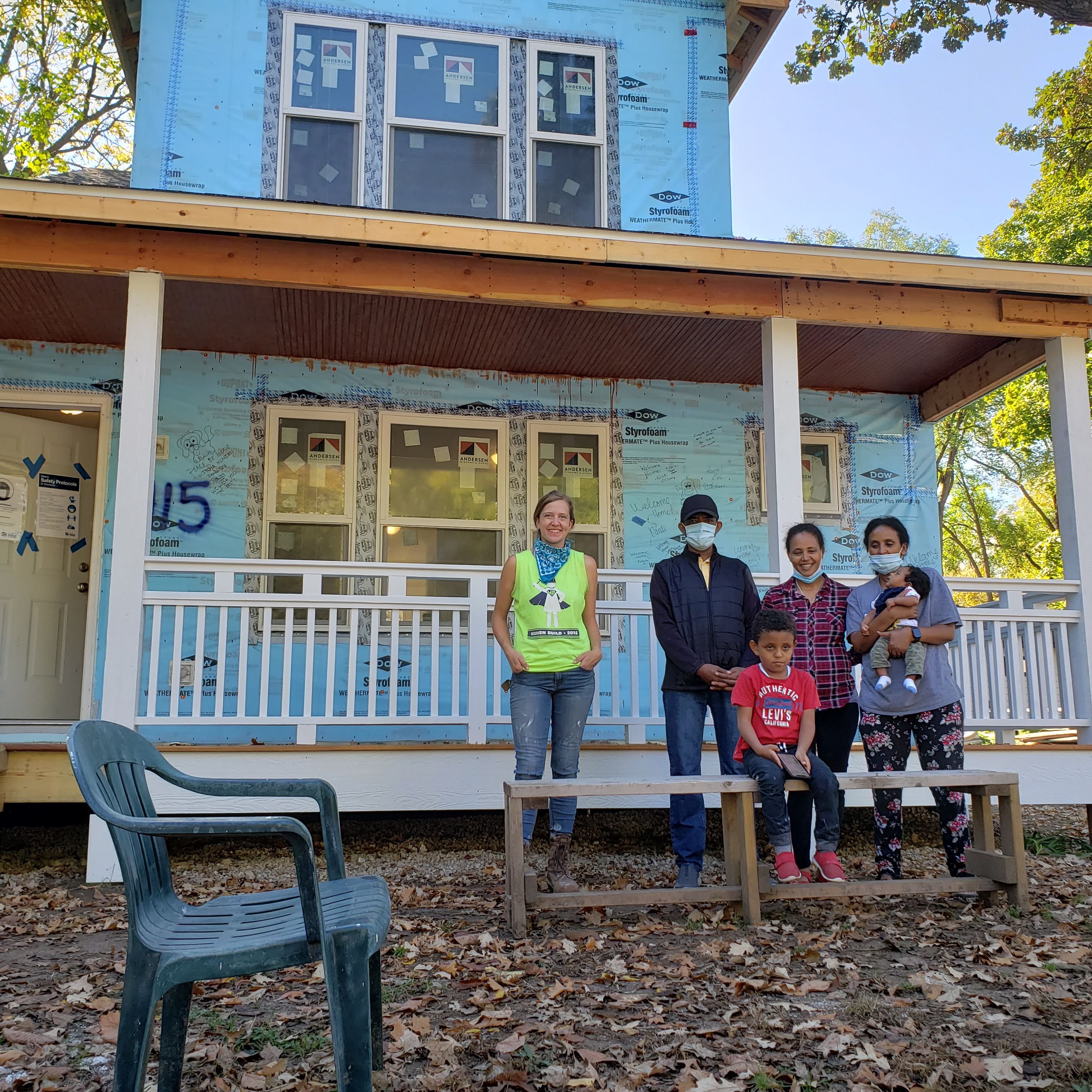 people standing in front of house