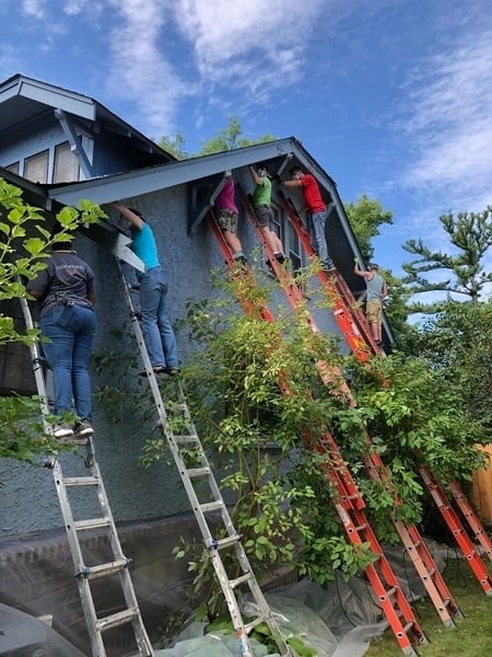 Volunteers painting Cynthia's home.