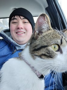 Chris with the brown and white cat.