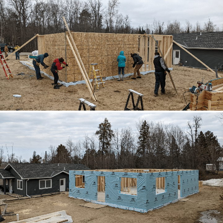 Volunteers raising the walls of a newly constructed house