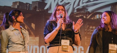 Jan speaking in front of an audience.