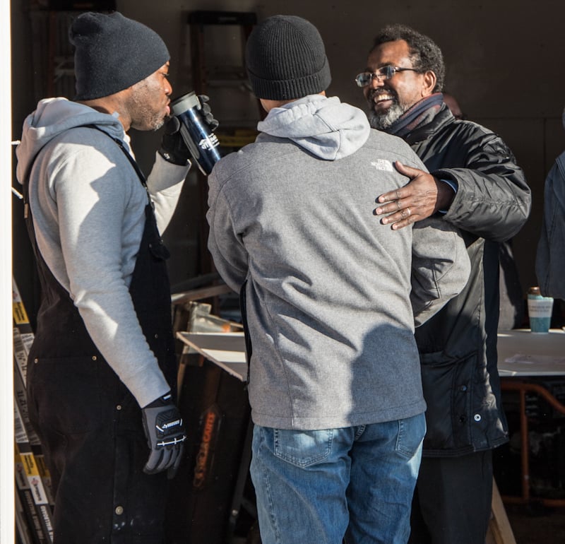 Hassan greeting coworkers at the all staff build
