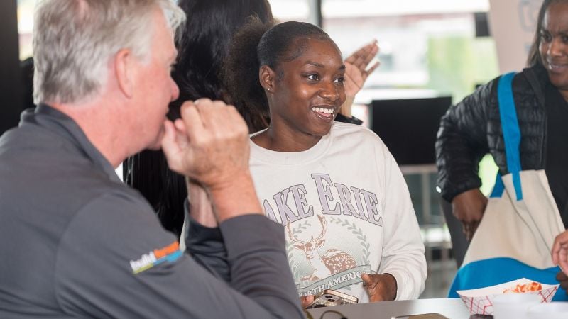 A homeowner talking at a table with CEO Chris.
