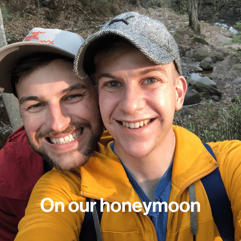 Two men in baseball caps smiling