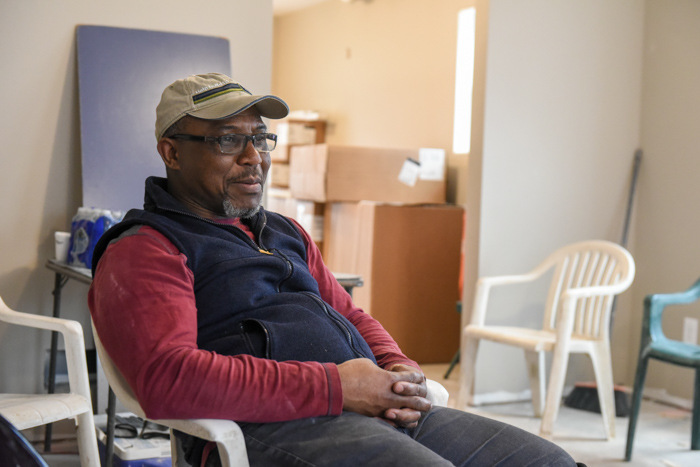 Edgar sitting in a chair at the build site.