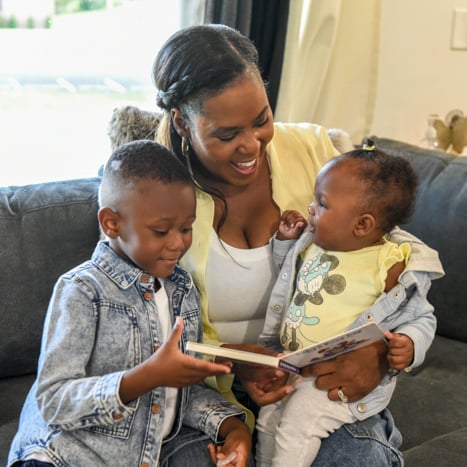 Monisha and children reading a book