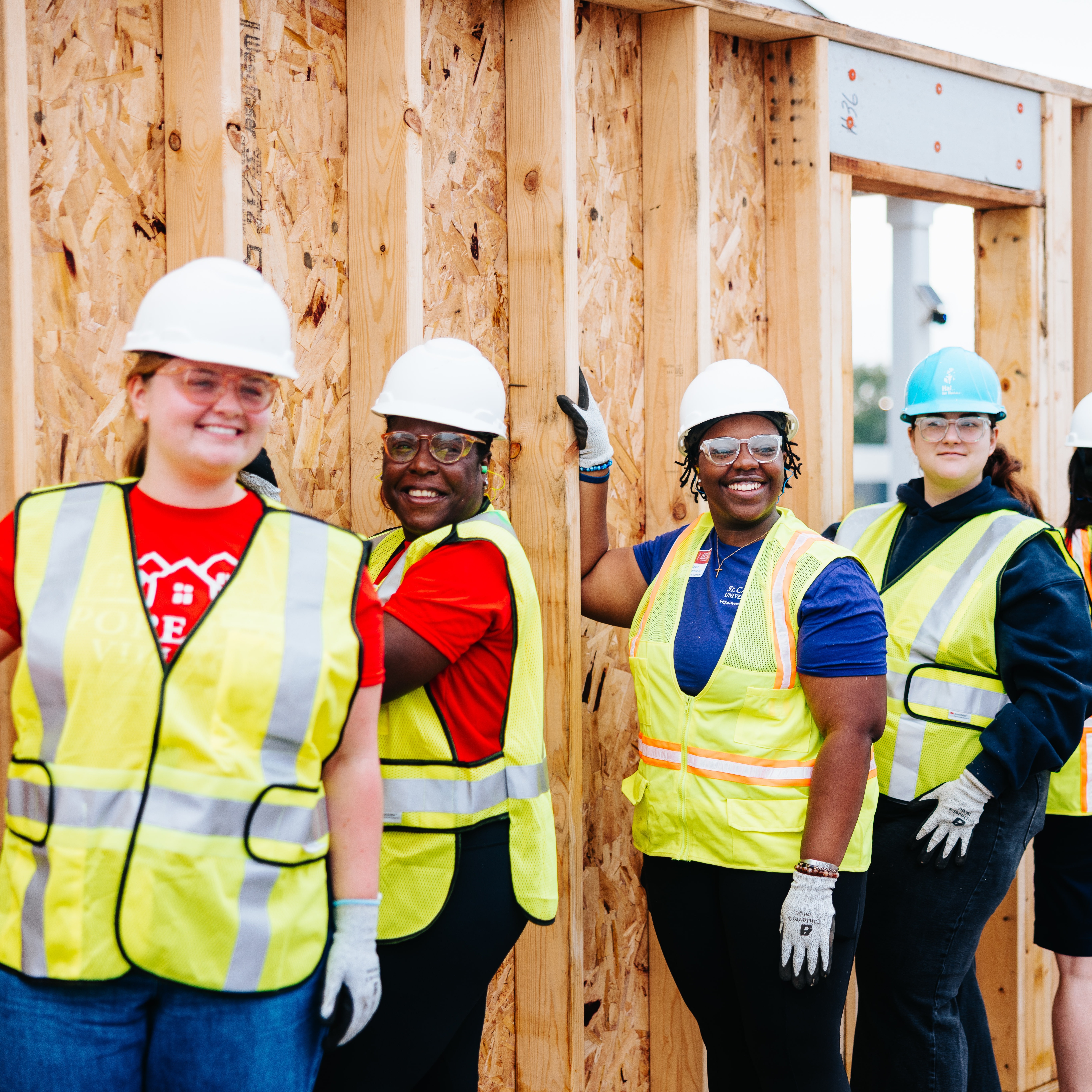 Volunteers holding wall structure.