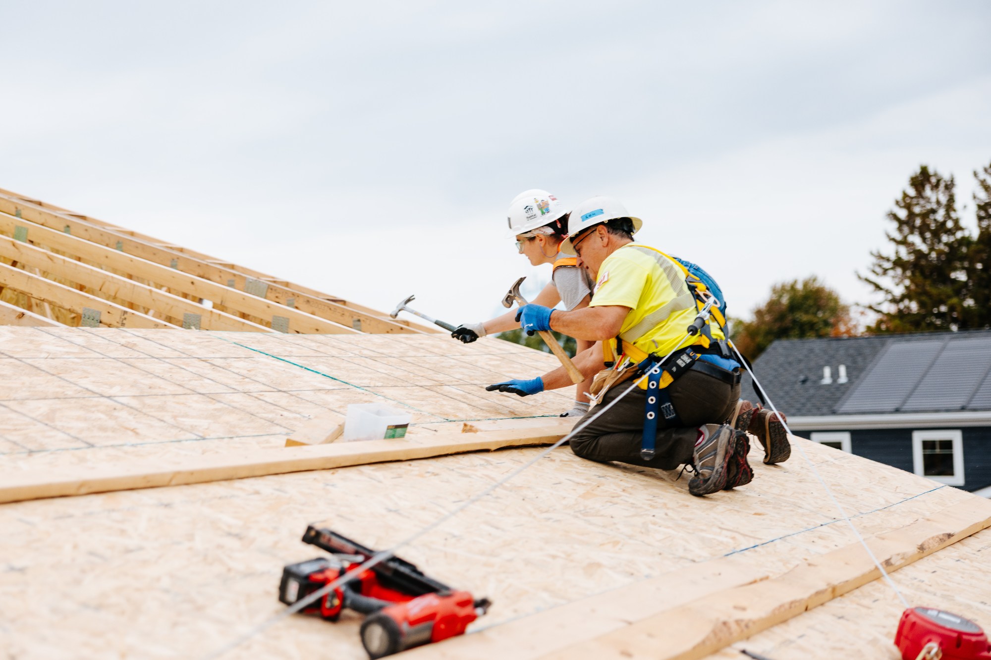 Volunteers building on a roof